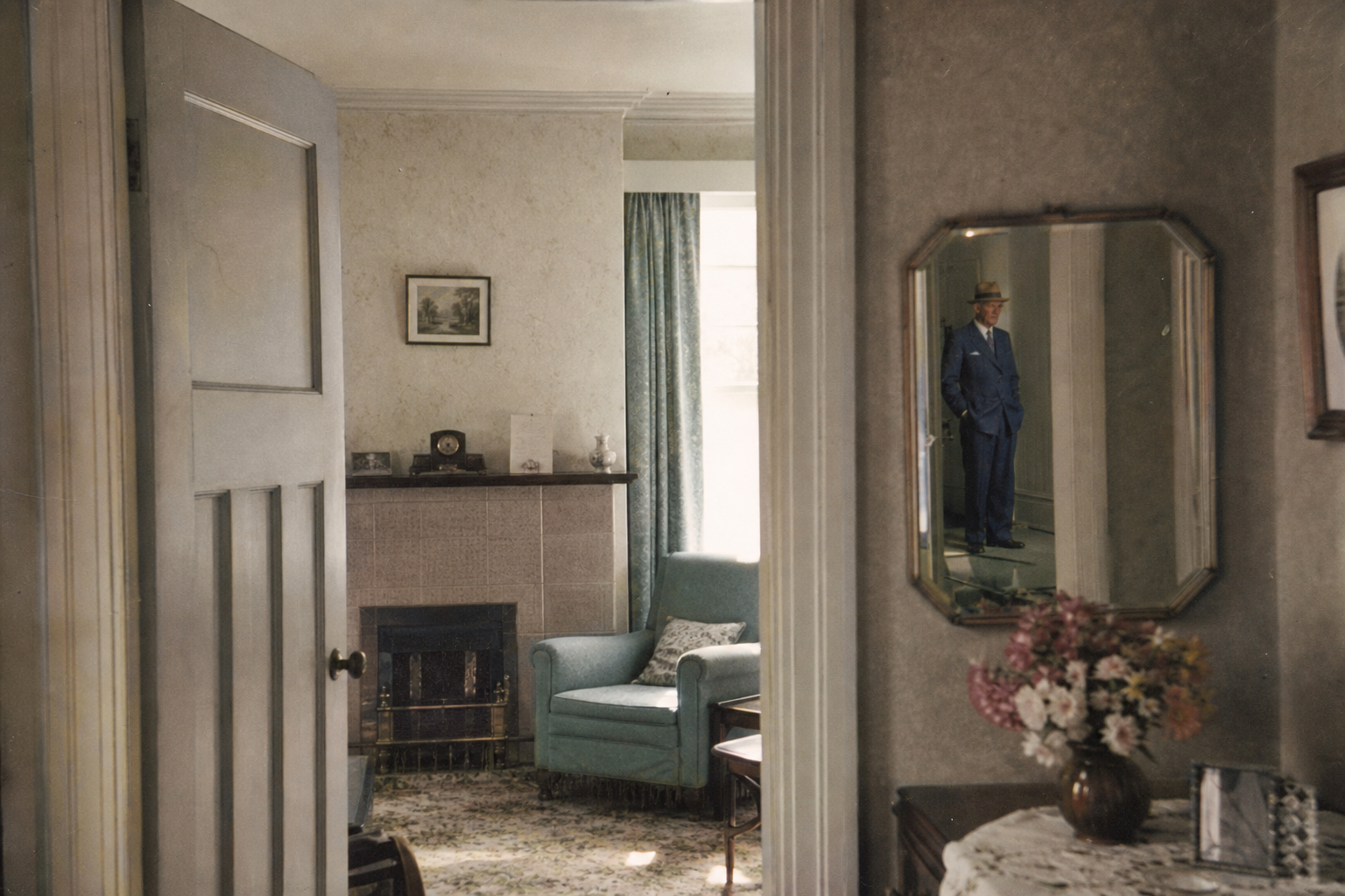 An empty period sitting room in which Charlie appears only in the mirror